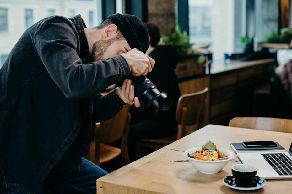 Photographer using photo composition rules to set up shot